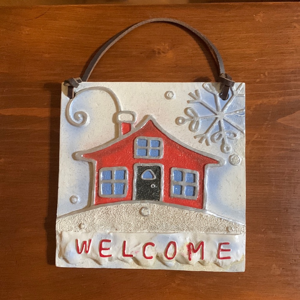 “WELCOME” Hanging Ceramic Plaque with a cozy home pictured